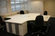 Cluster of radial desking finished in a white melamine board