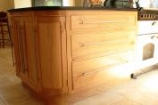 French oak, rounded corner unit with black granite worktop.